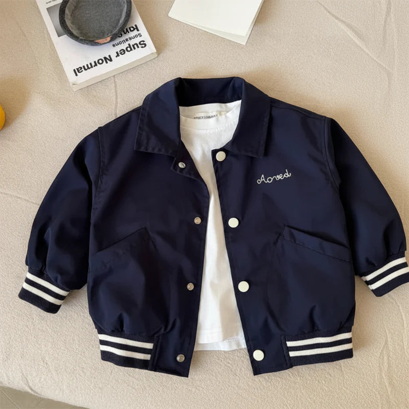 Blue baseball jacket laid flat with front snaps, slanted pockets, and striped cuffs and hem