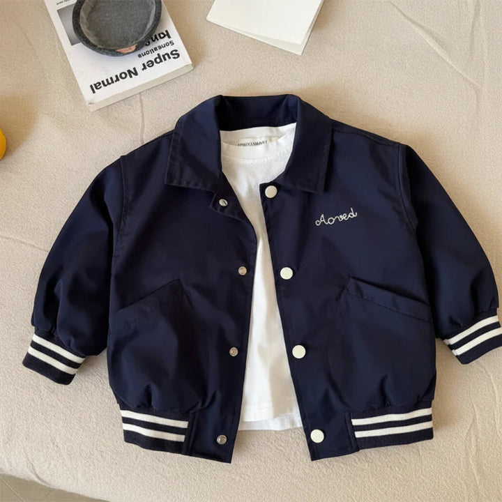 Blue baseball jacket laid flat with front snaps, slanted pockets, and striped cuffs and hem