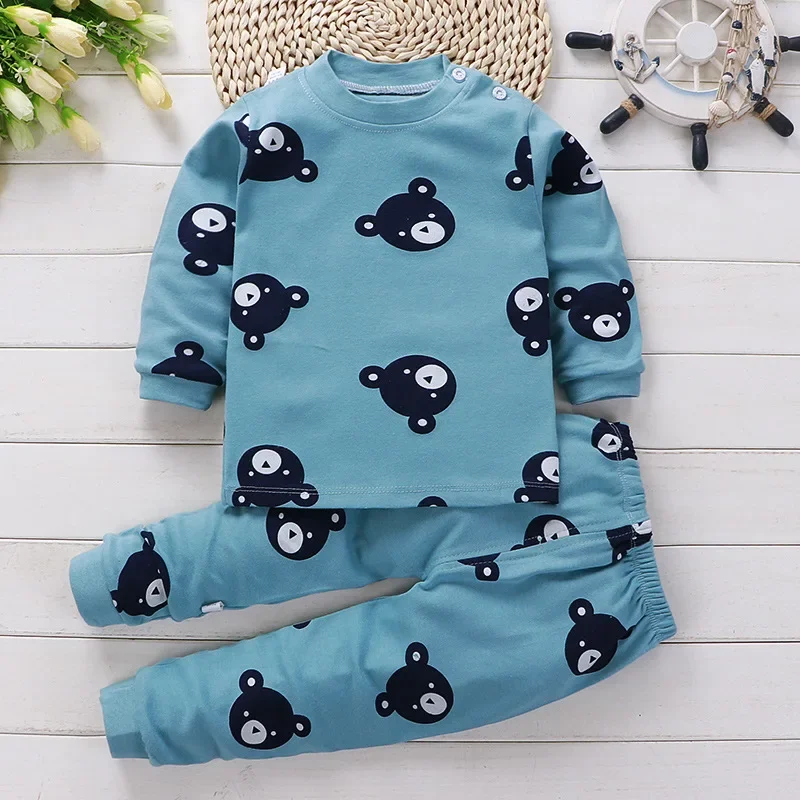 Blue pajama top and matching pants with an allover dark bear-face print