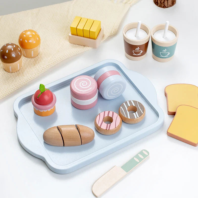 Blue serving tray with wooden pastries and bread, surrounded by cups, toast, and butter