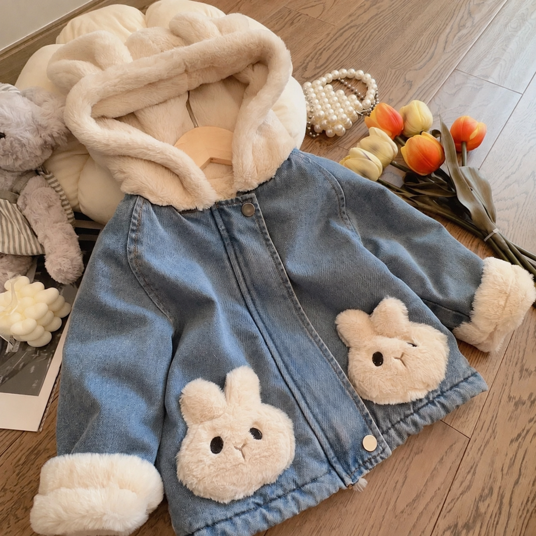 Front view of the zipped blue denim jacket with two cream bunny details and a plush hood