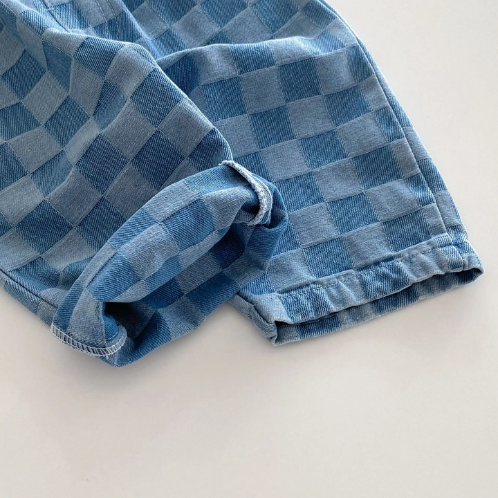 Close-up of blue checkerboard fabric and stitching along the hem