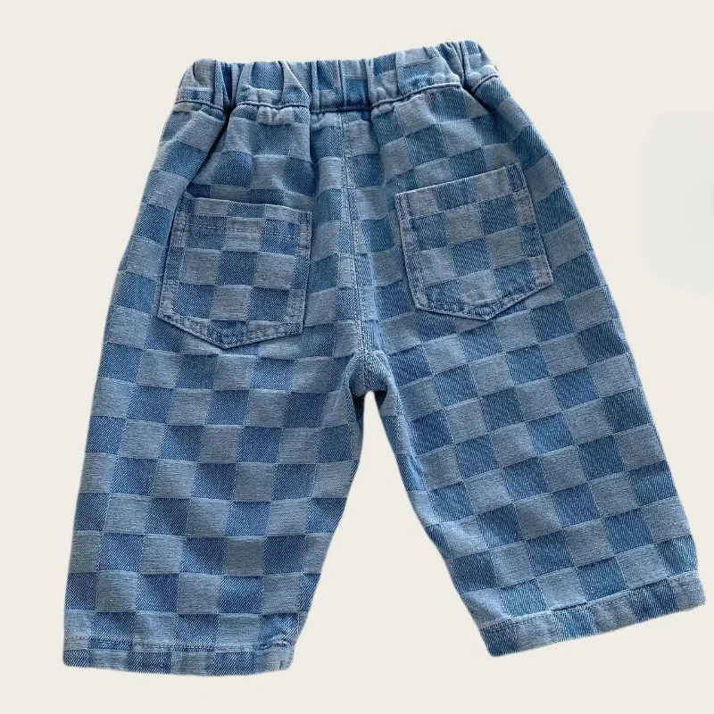 Back of blue checkerboard pants showing two patch pockets and an elastic waistband