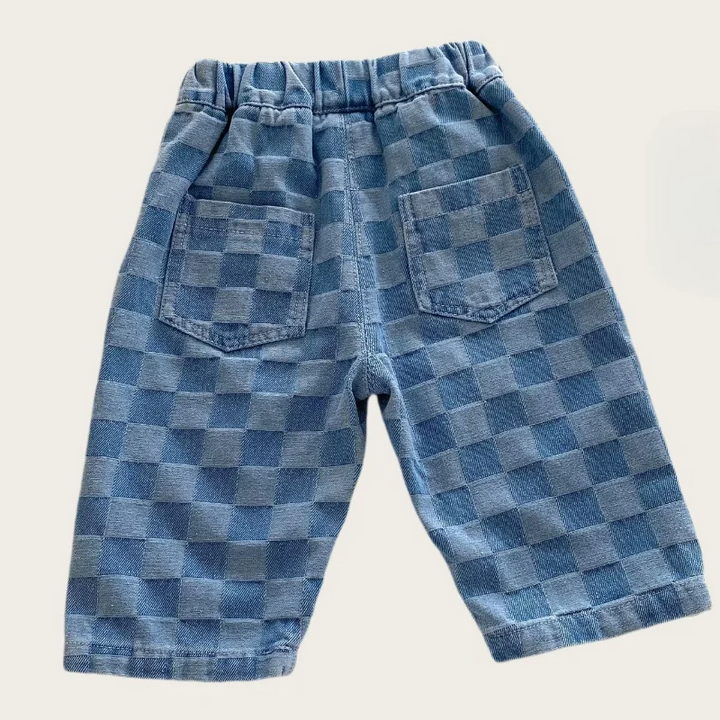 Back of blue checkerboard pants showing two patch pockets and an elastic waistband