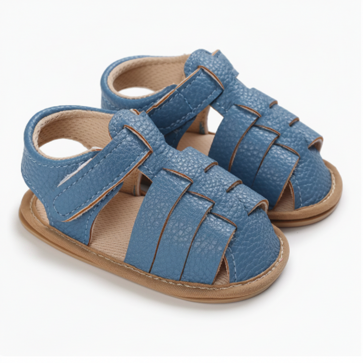 Pair of blue closed-toe baby sandals with interwoven straps and ankle fastenings
