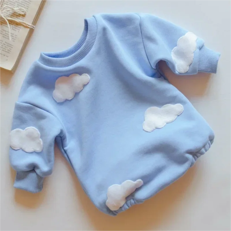 Blue cotton baby romper with raised white clouds, a ribbed neckline, and ribbed cuffs.