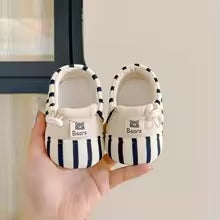 Pair of blue-and-cream striped baby shoes with cream interiors
