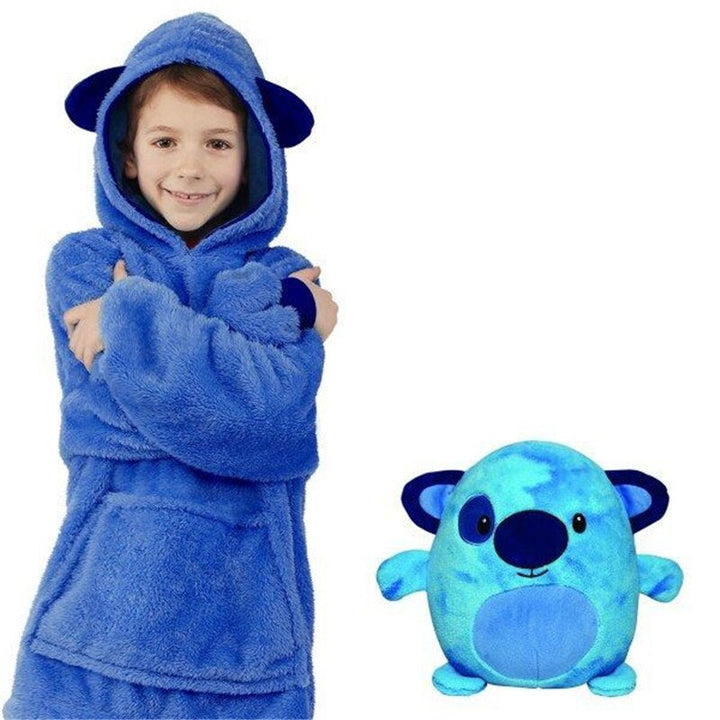 Child wearing the blue creature hoodie beside the blue plush toy with rounded ears.