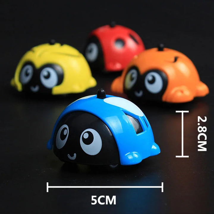 Blue animal toy car beside measurement labels, with yellow, red, and orange cars behind it