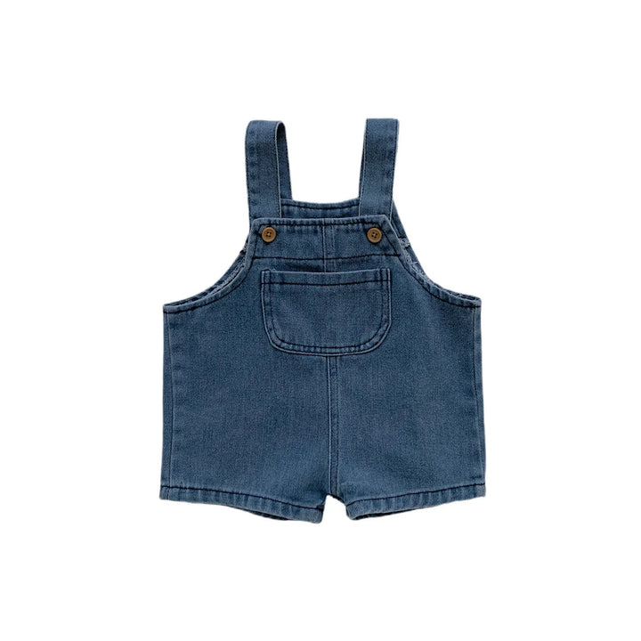 Front view of blue denim short overalls with a bib pocket and buttoned straps
