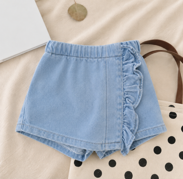 Blue denim skirt with a ruffled front panel, elastic waist and shorts underneath