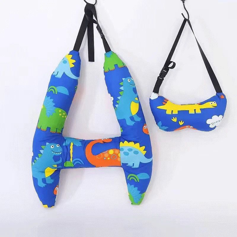 Blue dinosaur-print H-shaped car pillow and matching neck pillow hanging from black straps