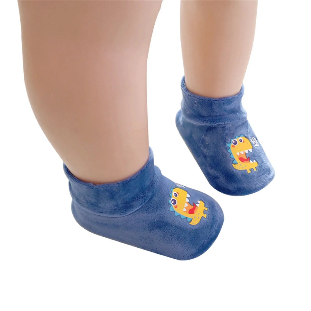 Blue dinosaur-print sock shoes with soft ankle openings, shown on a child