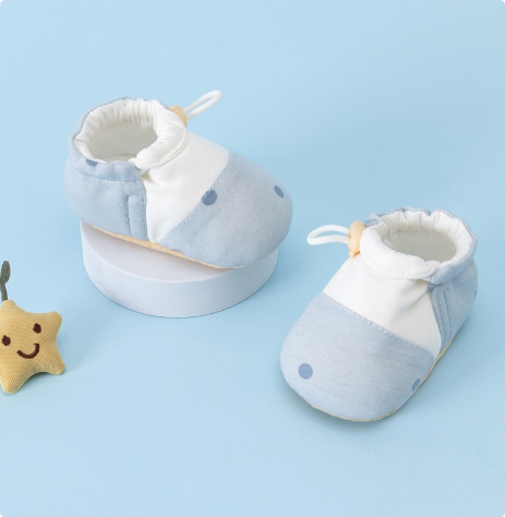 Light blue baby shoes with dot details and white ankle openings