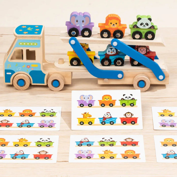 Blue wooden double-decker truck loaded with animal vehicles beside picture-matching cards.