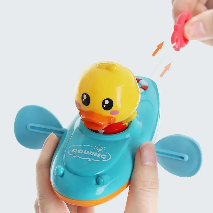 Hands holding a blue duck boat and lifting its rear pull tab
