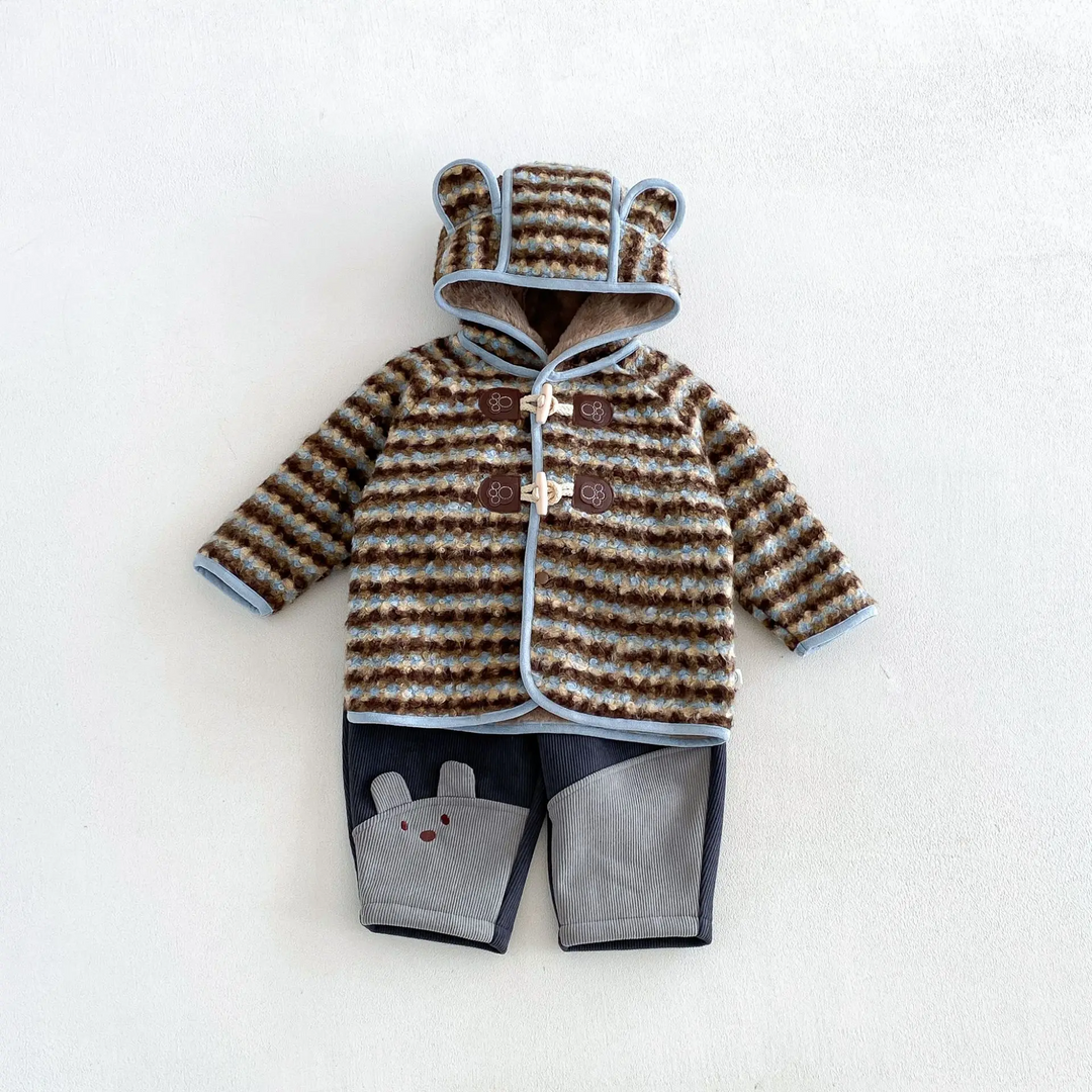 Blue striped ear-hood jacket paired with navy and gray animal-detail pants