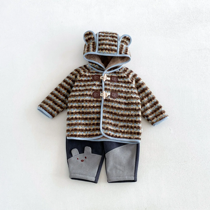Blue striped ear-hood jacket paired with navy and gray animal-detail pants