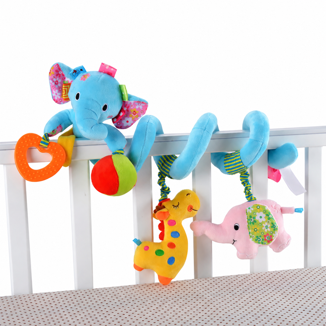 Blue elephant spiral toy on a crib rail with a heart, ball, giraffe, and pink animal.