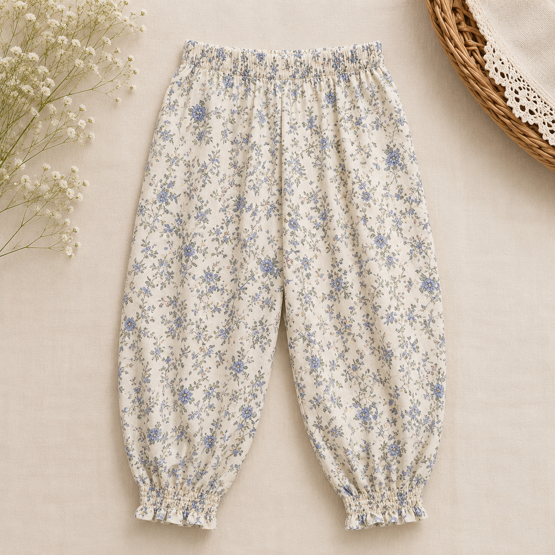Cream pants with blue floral print, an elastic waist, and gathered ankle cuffs