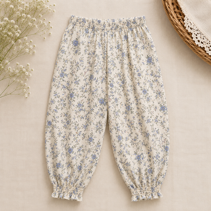 Cream pants with blue floral print, an elastic waist, and gathered ankle cuffs