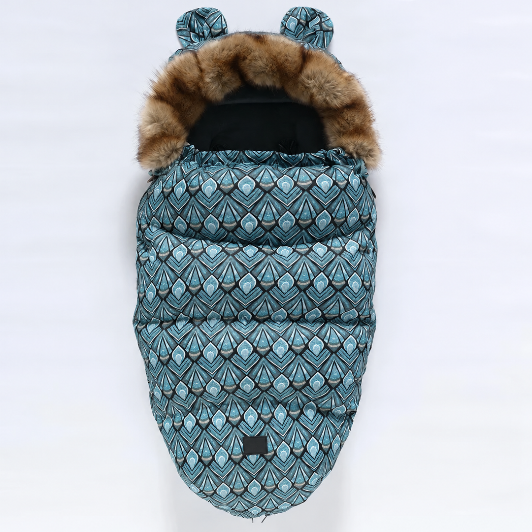 Blue geometric-print stroller footmuff with faux fur trim and matching patterned ears