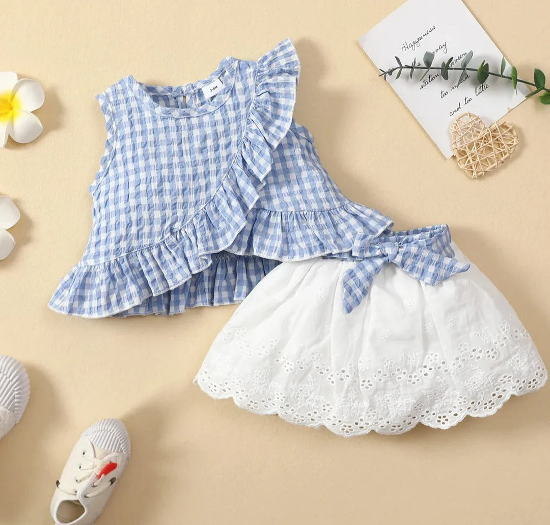 Blue gingham ruffle top with a white eyelet skirt and matching waist bow