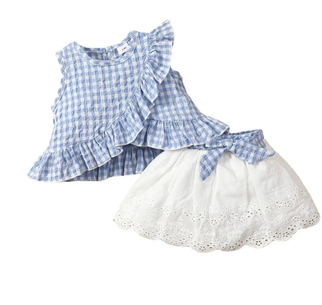 Blue gingham sleeveless top and white eyelet skirt displayed on a white background