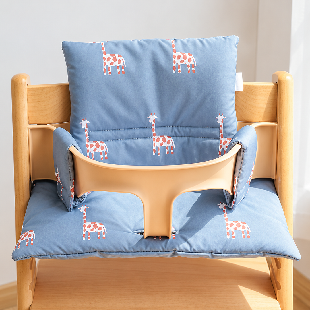 Blue high chair cushion with giraffe prints covering the seat and backrest