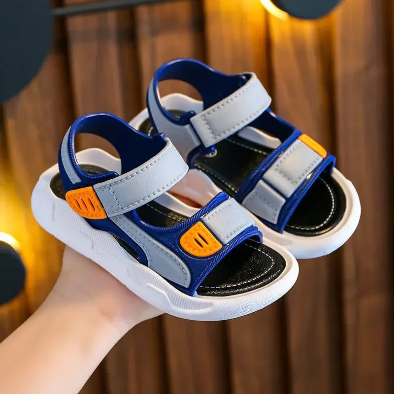 Blue and gray sandals with orange strap details, black footbeds, and white soles