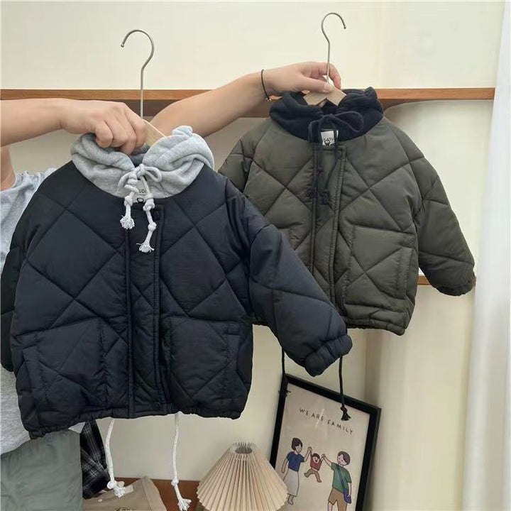 Blue and army green quilted jackets hanging side by side with contrasting hoods.