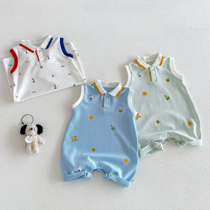 Light blue and light green polo rompers laid flat beside a folded white nautical-print romper
