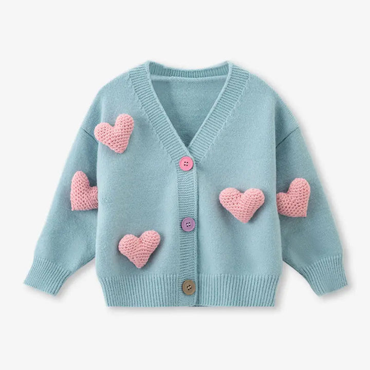 Front view of the blue long-sleeve cardigan with pink hearts and ribbed cuffs