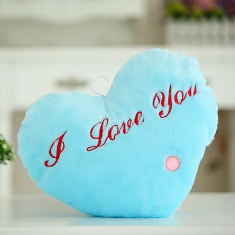 Blue heart-shaped plush pillow with red I Love You embroidery and a pink button