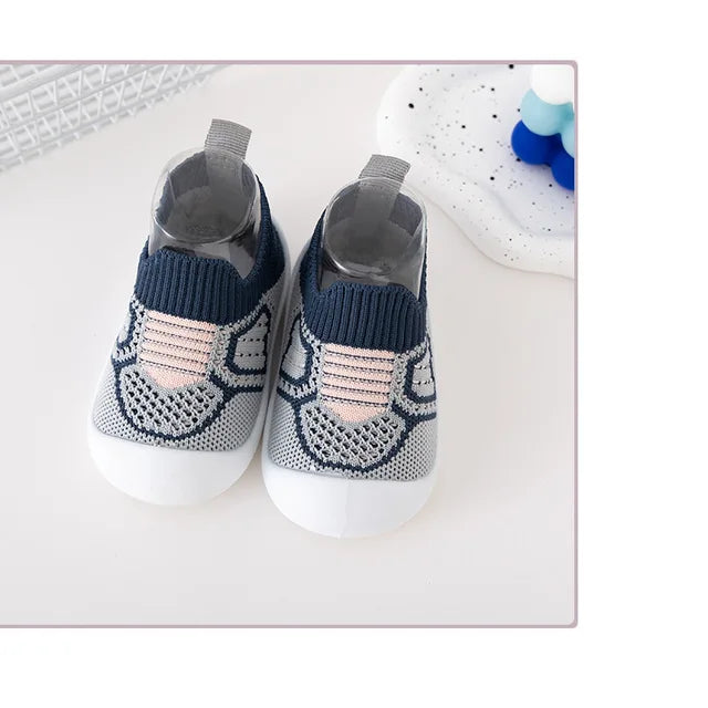 Pair of blue knit slip-on shoes with pale pink accents and white soles