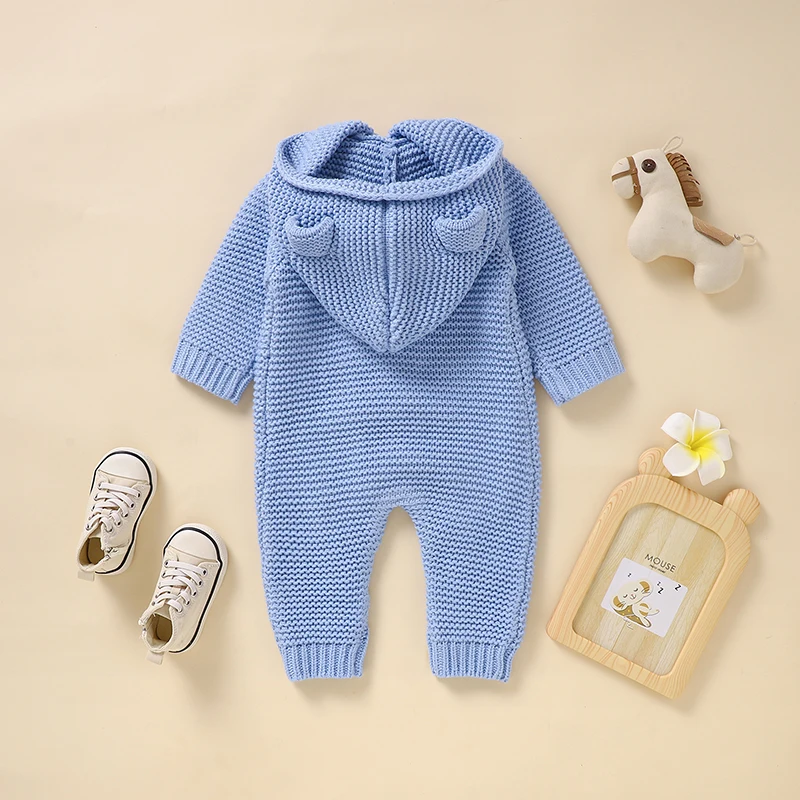 Back of the blue knitted baby jumpsuit with an attached ear-detail hood and ribbed cuffs