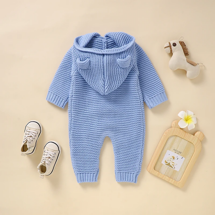 Back of the blue knitted baby jumpsuit with an attached ear-detail hood and ribbed cuffs