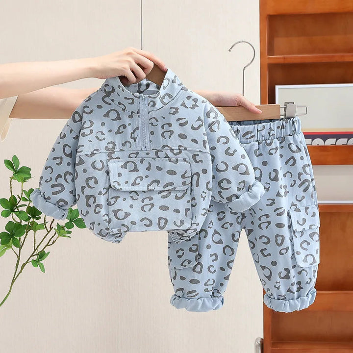 Blue leopard print two-piece outfit with a half-zip pullover and elastic-waist pants.