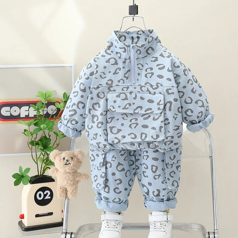 Blue leopard print outfit displayed with its front pocket, stand collar and matching pants.