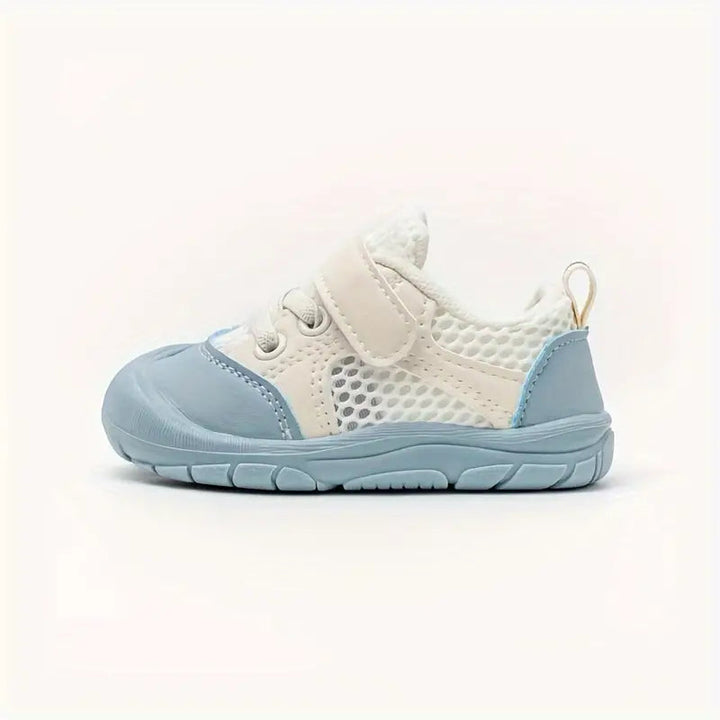 Side profile of a blue and white mesh baby shoe with an adjustable strap