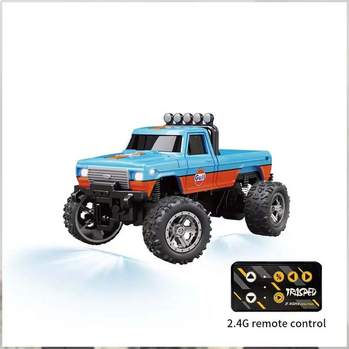 Blue-and-orange mini RC pickup truck with its compact 2.4 GHz remote.