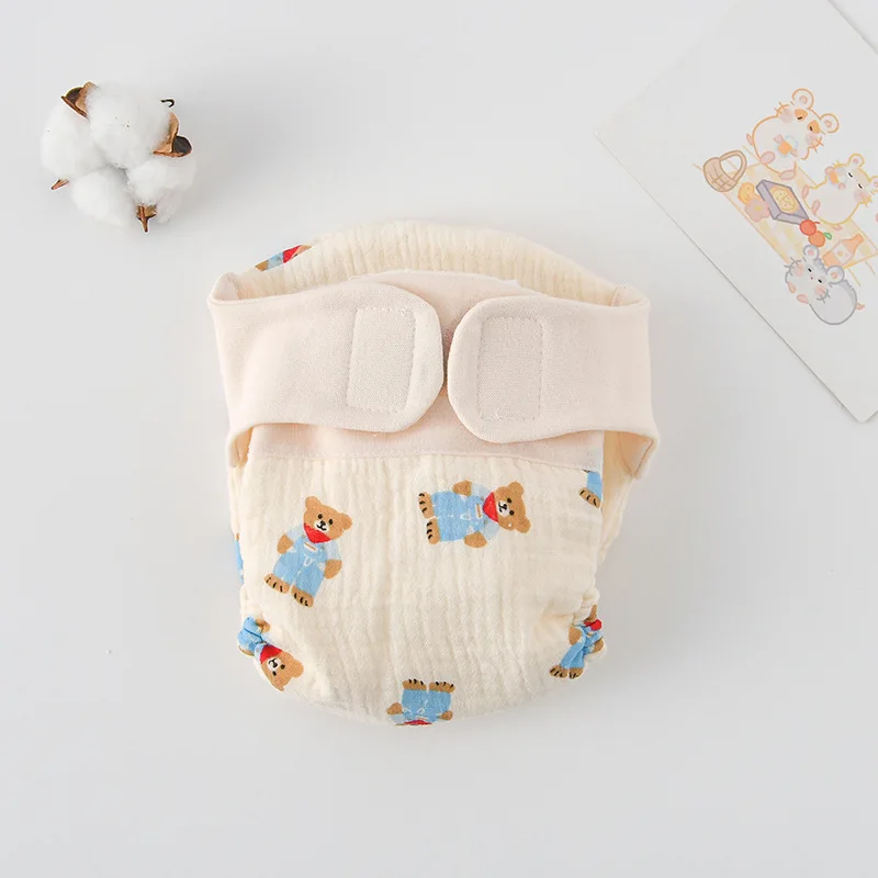 Cloth diaper with bears in blue outfits and a cream waistband