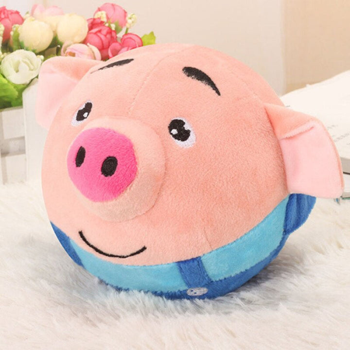 Pink pig toy ball with a blue outfit and a smiling face