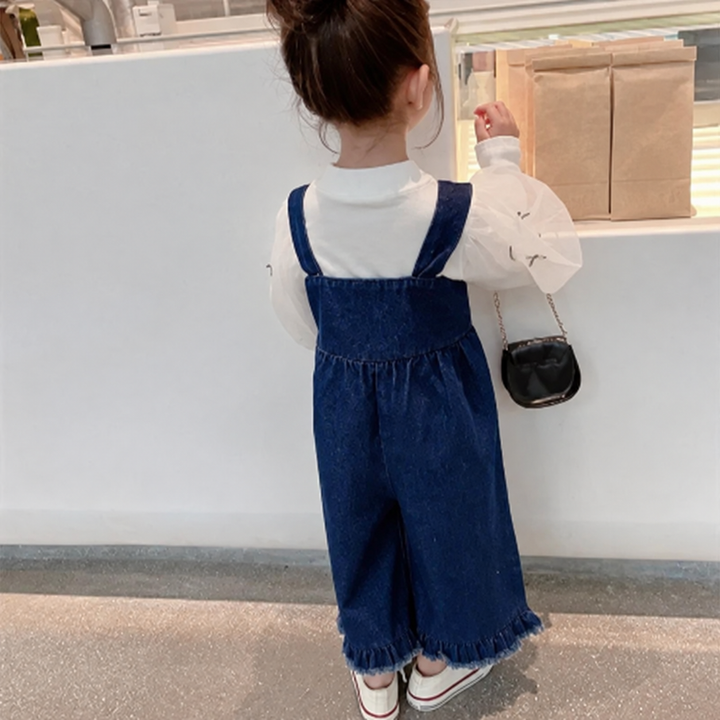 Back view of blue overalls showing shoulder straps and a gathered waist