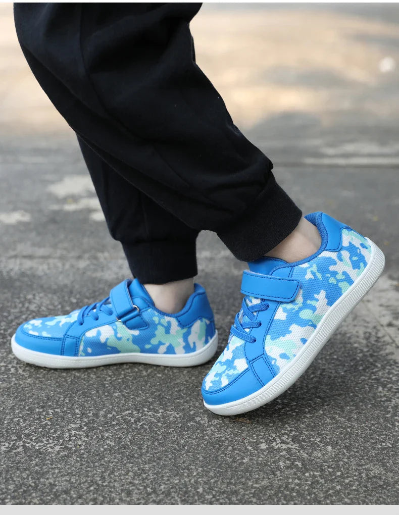 Side view of blue patterned sneakers worn on pavement