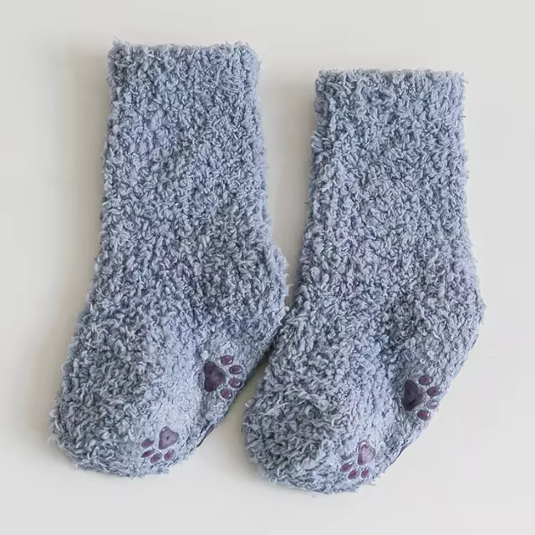 Blue fleece socks with paw-print details on the soles