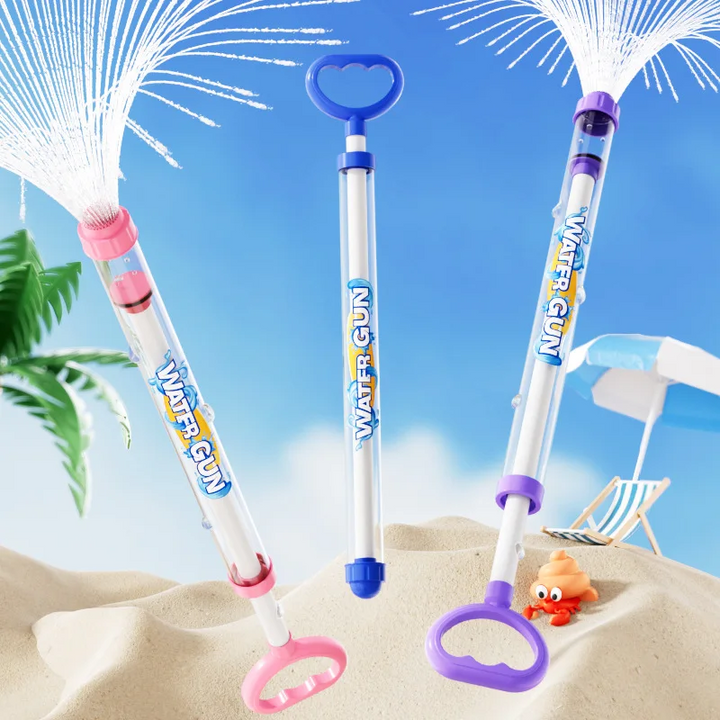 Blue, pink, and purple pump water guns displayed together in a beach scene.
