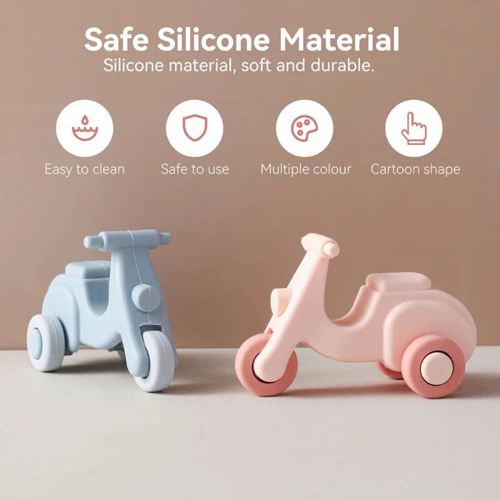 Blue and pink silicone scooter teethers with rounded bodies and easy-grip openings