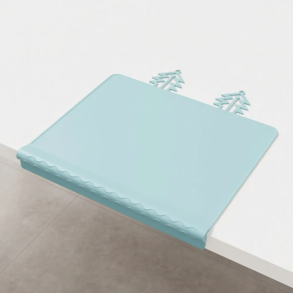 Blue silicone placemat with its front edge draped over a white table