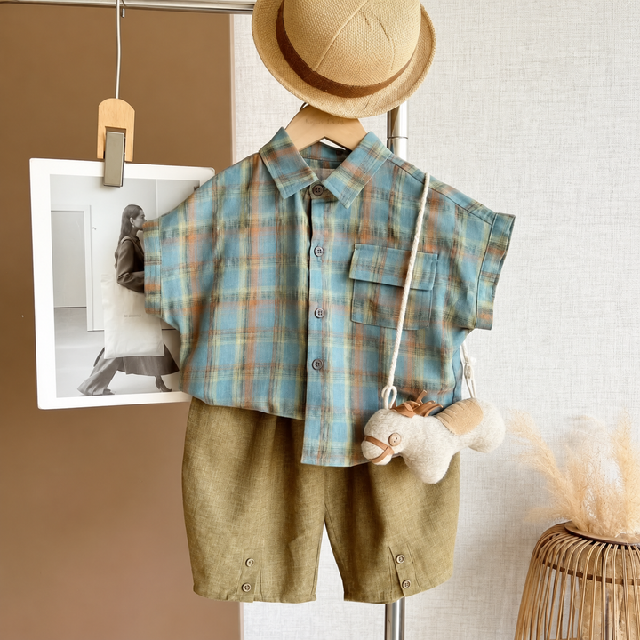 Blue plaid short-sleeve shirt and olive-green shorts displayed together on a hanger